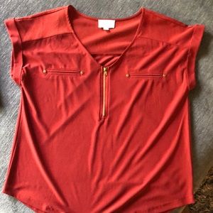 Women’s shirt with front zipper and “scoop” bottom